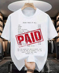 White t-shirt with religious text and 'PAID' stamp in a store setting
